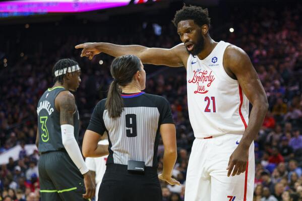 Philadelphia 76ers' Joel Embiid, right, reacts to a call by official Natalie Sago, center, during the first half of an NBA basketball game against the Minnesota Timberwolves, Saturday, Nov. 19, 2022, in Philadelphia. (AP Photo/Chris Szagola)