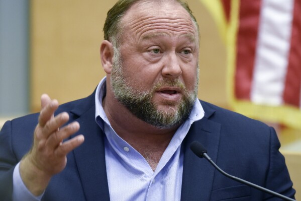 FILE - Conspiracy theorist Alex Jones takes the witness stand to testify at the Sandy Hook defamation damages trial at Connecticut Superior Court in Waterbury, Conn. Thursday, Sept. 22, 2022. A Texas judge has ruled that Jones cannot use bankruptcy protection to avoid paying nearly $1 billion to families who sued over his conspiracy theories that the Sandy Hook school massacre was a hoax. (Tyler Sizemore/Hearst Connecticut Media via AP, Pool, File)