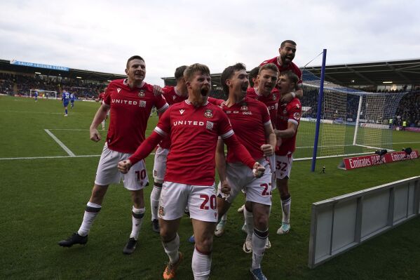 Wrexham's Thomas O'Connor, center right, celebrates scoring their side's first goal of the game with teammates during their English FA Cup Third Round soccer match at The Croud Meadow, Shrewsbury, England, Sunday, Jan. 7, 2024. (Nick Potts/PA via AP)