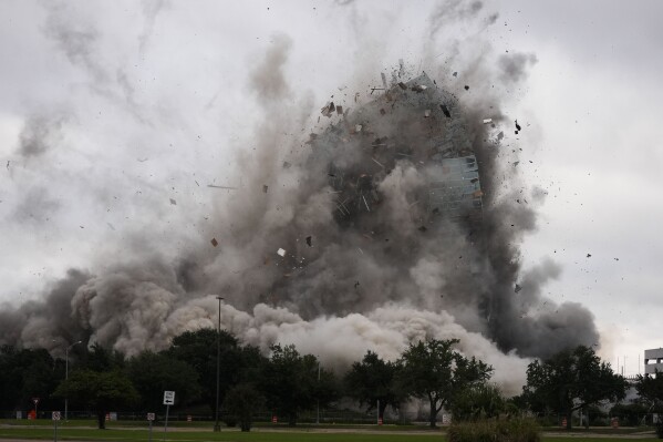 The Hertz Tower, that was heavily damaged after Hurricanes Laura and Delta in 2020, is imploded in Lake Charles, La., Saturday, Sept. 7, 2024. (AP Photo/Gerald Herbert)