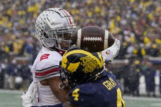 Michigan defensive back Vincent Gray (4) breaks up a pass intended for Ohio State wide receiver Chris Olave (2) during the first half of an NCAA college football game, Saturday, Nov. 27, 2021, in Ann Arbor, Mich. (AP Photo/Carlos Osorio)