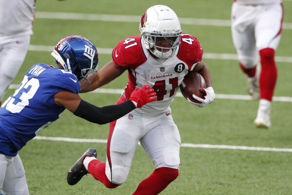 Arizona Cardinals' Kenyan Drake, right, runs the ball while trying to keep New York Giants' Logan Ryan away during the second half of an NFL football game, Sunday, Dec. 13, 2020, in East Rutherford, N.J. (AP Photo/Noah K. Murray)