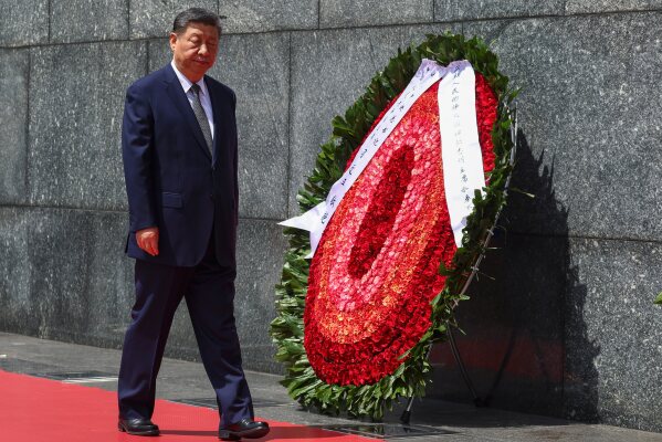 Chinese President Xi Jinping walks next to a wreath at the Ho Chi Minh Mausoleum during his visit to Hanoi, Vietnam, Tuesday, April 15, 2025. (Athit Perawongmetha/Pool Photo via AP)