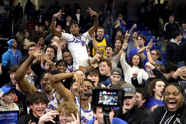 DePaul players and fans celebrate the team's 73-72 upset over No. 8 ranked Xavier in an NCAA college basketball game Wednesday, Jan. 18, 2023, in Chicago. (AP Photo/Charles Rex Arbogast)