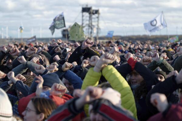 Participants at a rally on the edge of the open pit Luetzerath, Germany, Sunday, Jan.8, 2023. Luetzerath is to be mined for the expansion of the Garzweiler II opencast lignite mine. (Henning Kaiser/dpa via AP)