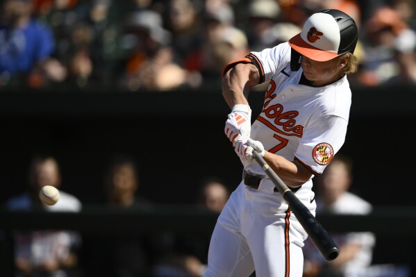 Baltimore Orioles' Jackson Holliday swings for a single during the seventh inning of a baseball game against the Milwaukee Brewers, Sunday, April 14, 2024, in Baltimore. This was his first major league hit. (AP Photo/Nick Wass)