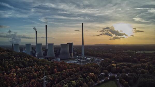 FILE - The sun sets behind a coal-fired power plant in Gelsenkirchen, Germany, Oct. 22, 2022. A new report from doctors and other health experts says the world's fossil fuel addiction is making the world sicker and is killing people. (AP Photo/Michael Sohn, File)
