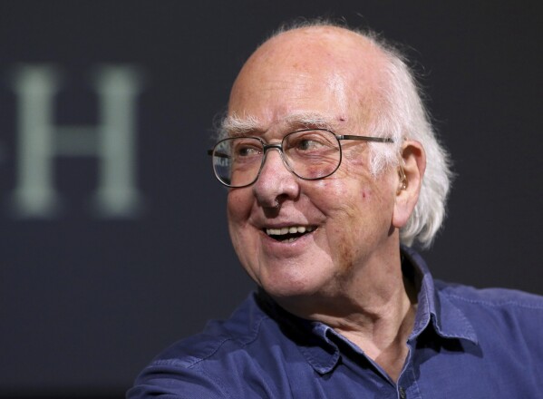 FILE - Britain's Professor Peter Higgs smiles during a press conference in Edinburgh, Scotland, on Oct. 11, 2013. The University of Edinburgh says Nobel prize-winning physicist Peter Higgs, who proposed the existence of the Higgs boson particle, has died at 94. Higgs predicted the existence of a new particle — the so-called Higgs boson — in 1964. But it would be almost 50 years before the particle’s existence could be confirmed at the Large Hadron Collider. Higgs won the 2013 Nobel Prize in Physics for his work, alongside Francois Englert of Belgium. (AP Photo/Scott Heppell, File)