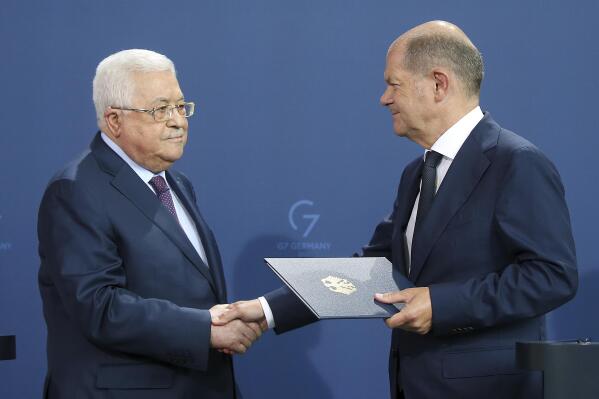 German Chancellor Olaf Scholz, right,  and Mahmoud Abbas, President of the Palestinian Authority, shake hands after a press conference after their talks in Berlin, Germany, Tuesday, Aug.16, 2022. (Wolfgang Kumm/dpa via AP)
