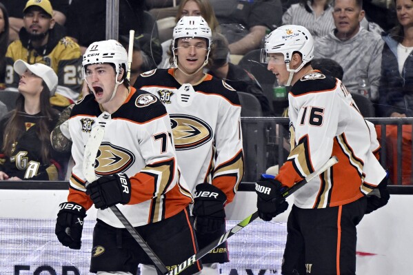 Anaheim Ducks right wing Frank Vatrano (77) celebrates a goal against the Vegas Golden Knights with teammates Trevor Zegras (11) and Ryan Strome (16) during the third period of an NHL hockey game Thursday, April 18, 2024, in Las Vegas. (AP Photo/David Becker)