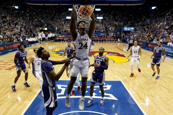 Kansas forward K.J. Adams Jr. (24) dunks the ball during the first half of an NCAA college basketball game against Kansas State Tuesday, Jan. 31, 2023, in Lawrence, Kan. (AP Photo/Charlie Riedel)