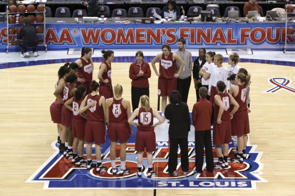 FILE - The Stanford team listen to their coach Tara VanDerveer, upper center, during basketball practice at the NCAA Women's Final Four, Saturday, April 4, 2009, in St. Louis. VanDerveer, the winningest basketball coach in NCAA history, announced her retirement Tuesday night, April 9, 2024, after 38 seasons leading the Stanford women’s team and 45 years overall. (AP Photo/Jeff Roberson, File)