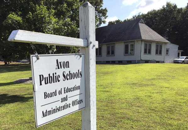This July 12, 2019, photo shows the board of education offices in Avon, Conn. A denial of a service cyberattack overwhelmed the Avon school district's technology systems in late 2017 and brought to a halt instruction built around access to the internet. The FBI said cyberattacks have become common at schools, which are attractive targets because they hold sensitive data and provide critical public services. Malicious use of the data could lead to bullying, tracking and identity theft, the agency said. (AP Photo/Michael Melia)