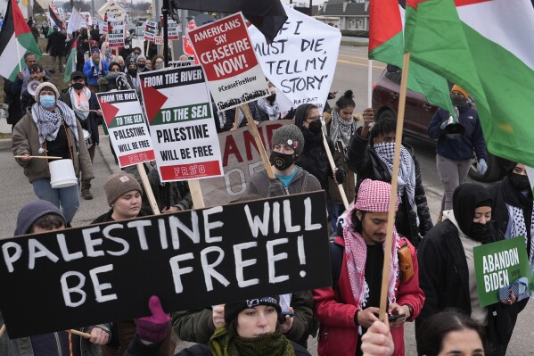 Pro-Palestinian demonstrators march during a visit by President Joe Biden in Warren, Mich., Thursday, Feb. 1, 2024. (AP Photo/Paul Sancya)