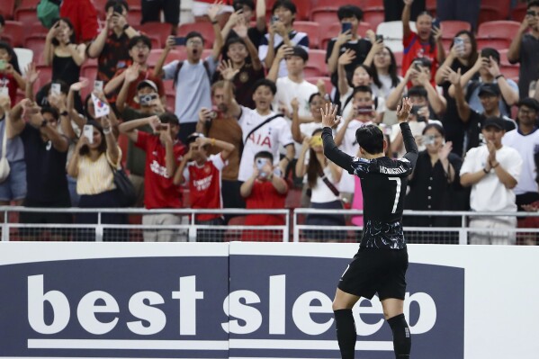 Son Heung Min of South Korea waves to the fans after the match during 2026 FIFA World Cup Asian 2nd Qualifier soccer match between Singapore and South Korea at the National Stadium on Thursday June 6, 2024 in Singapore. (AP Photo/Suhaimi Abdullah)