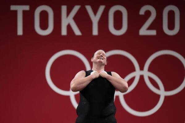 Laurel Hubbard of New Zealand says "Thank you" and bows after a lift, in the women's +87kg weightlifting event at the 2020 Summer Olympics, Monday, Aug. 2, 2021, in Tokyo, Japan. (AP Photo/Luca Bruno)