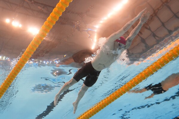 Adam Peaty of Britain competes in the men's 100-meter breaststroke final at the World Aquatics Championships in Doha, Qatar, Monday, Feb. 12, 2024. (AP Photo/Lee Jin-man)