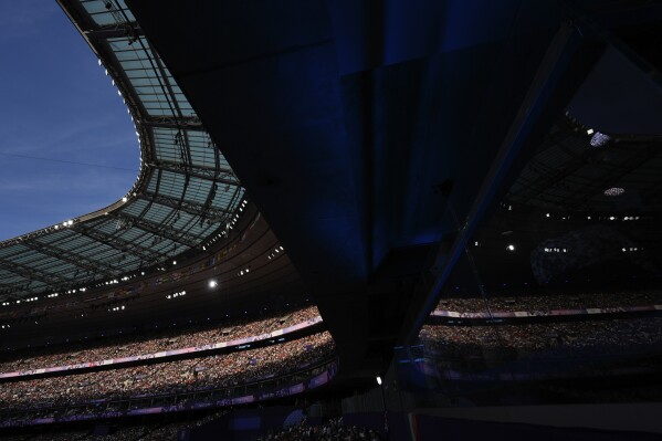 Fans fill the stands inside Stade de France to watch athletics competition, at the 2024 Summer Olympics, Tuesday, Aug. 6, 2024, in Saint-Denis, France. (AP Photo/Rebecca Blackwell)