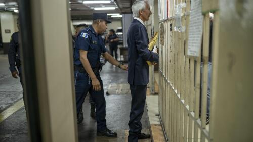 Award-winning journalist Jose Ruben Zamora is escorted by police after ending the first day of his trial on money laundering charges, in Guatemala City, Tuesday, May 2, 2023. (AP Photo/Santiago Billy)