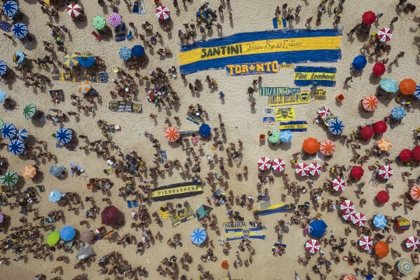 Argentine Boca Juniors fans gather on Copacabana beach the day before their team faces Brazil's Fluminense at the Copa Libertadores championship match in Rio de Janeiro, Brazil, Friday, Nov. 3, 2023. (AP Photo/Bruna Prado)