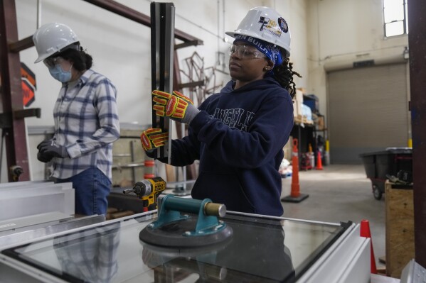 Chyanne Henderson practices putting together a window during an Ironworkers Local 63 pre-apprenticeship class Wednesday, March 26, 2025, in Broadview, Ill. (AP Photo/Erin Hooley)