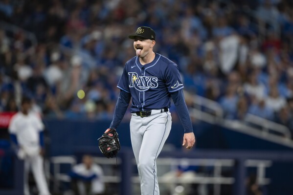 Tampa Bay Rays pitcher Tyler Alexander (14) reacts while walking back to the dugout after the seventh inning of the team's baseball game against the Toronto Blue Jays on Friday, May 17, 2024, in Toronto. (Christopher Katsarov/The Canadian Press via AP)