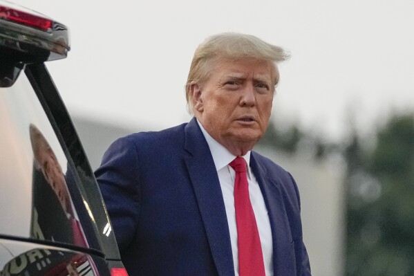 Former President Donald Trump walks to speak with reporters before departure from Hartsfield-Jackson Atlanta International Airport, Thursday, Aug. 24, 2023, in Atlanta. (AP Photo/Alex Brandon)