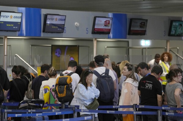 Passengers wait in a queue, to enter a flight to Israel, at the Eleftherios Venizelos International Airport in Athens, Greece, Tuesday, Oct. 10, 2023. From Athens to New York, some Israeli citizens are rushing to airports and diving into online chat groups for help, desperate to make their way to the country after Hamas militants attacked. (AP Photo/Thanassis Stavrakis)