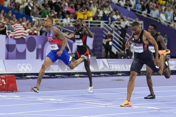 Quincy Hall, of the United States, celebrates after winning the men's 200-meter semifinal at the 2024 Summer Olympics, Wednesday, Aug. 7, 2024, in Saint-Denis, France. (AP Photo/Matthias Schrader)