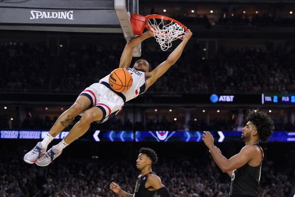 Connecticut guard Andre Jackson Jr. dunks the ball over Miami forward Norchad Omier, right, during the second half of a Final Four college basketball game in the NCAA Tournament on Saturday, April 1, 2023, in Houston. (AP Photo/David J. Phillip)