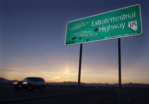 FILE - In this April 10, 2002, file photo, a vehicle moves along the Extraterrestrial Highway near Rachel, Nev., the closest town to Area 51. The U.S. Air Force has warned people against participating in an internet joke suggesting a large crowd of people "storm Area 51," the top-secret Cold War test site in the Nevada desert. (AP Photo/Laura Rauch, File)