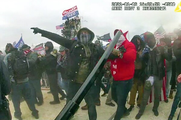 This image from police body-worn camera video, contained and annotated in the Justice Department's government's sentencing memorandum, supporting the sentencing of Brian Mock, shows Mock at the U.S. Capitol on Jan. 6, 2021, in Washington. Mock, the owner of a landscaping company and a former debt collector, was arrested for helping other rioters remove police barricades and committing four separate assaults against police officers who were attempting to block the rioters鈥� progression. (Department of Justice via 番茄直播)
