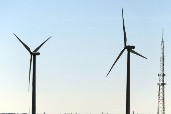Land-based wind turbines spin in Atlantic City. N.J., on Nov. 3, 2023. On Tuesday, April 30, 2024, New Jersey utility regulators opened a fourth round of solicitations for new offshore wind farm proposals to join the three that already have preliminary approval. (AP Photo/Wayne Parry)