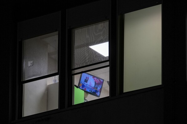 A television shows news about Pope Francis in a room of the Agostino Gemelli Polyclinic, in Rome, Sunday, Feb. 23, 2025, where the pontiff is hospitalized for pneumonia since Friday, Feb. 14. (AP Photo/Andrew Medichini)