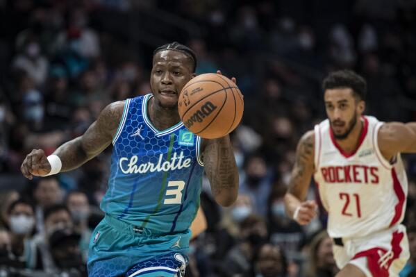 Charlotte Hornets guard Terry Rozier (3) drives the ball up court past Houston Rockets guard Trevelin Qeen (21) during the first half of an NBA basketball game Monday, Dec. 27, 2021, in Charlotte, N.C. (AP Photo/Matt Kelley)