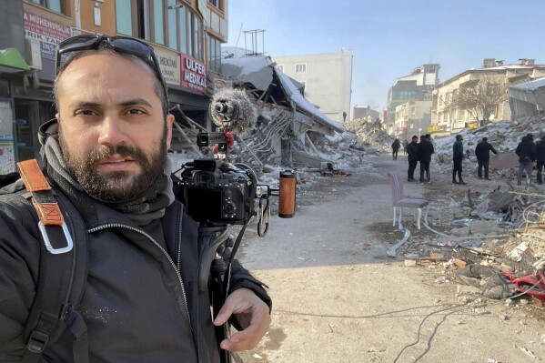 In this photo provided by Reuters, Issam Abdallah, a videographer for the news agency, poses for a selfie while working in Maras, Turkey, on Feb. 11, 2023. Abdallah was killed Friday, Oct. 13, 2023, when an Israeli shell landed in a gathering of international journalists covering clashes on the border in south Lebanon. Six other journalists were injured in the incident. (Issam Abdallah/Reuters via AP)