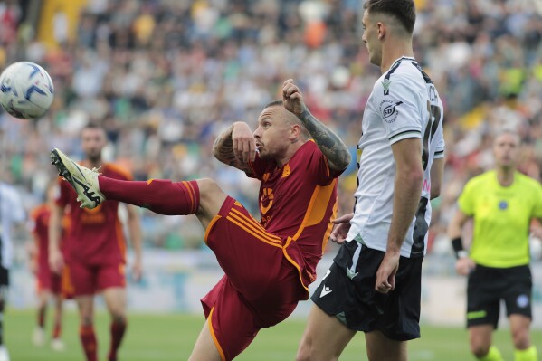 FILE - Roma's Angelino reaches for the ball during the Serie A soccer match between Udinese and Roma at the Bluenergy Stadium in Udine, Italy, Sunday, April 14, 2024. Roma said Friday, May 31, 2024, it has signed Angeliño from Leipzig after making the Spanish left back's loan deal permanent. (Andrea Bressanutti/LaPresse via AP)
