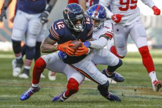 FILE - New York Giants safety Logan Ryan (23) tackles Chicago Bears wide receiver Allen Robinson (12) during the second half of an NFL football game Jan. 2, 2022, in Chicago. Robinson could be on his way out after going from back-to-back seasons with more than 1,100 yards to finishing with 410 playing under the franchise tag. (AP Photo/Kamil Krzaczynski, File)