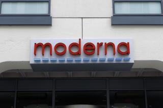 FILE - A sign marks an entrance to a Moderna building in Cambridge, Mass., on Monday, May 18, 2020. On Wednesday, Jan. 26, 2022, the pharmaceutical company announced it has begun testing an omicron-specific version of its COVID-19 vaccine in healthy adults, the same week that competitor Pfizer began similar research with its reformulated shots. (AP Photo/Bill Sikes, File)