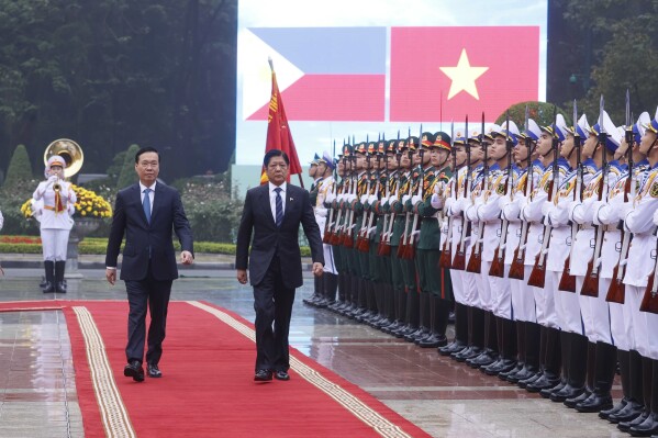 Philippine President Ferdinand Marcos Jr., right, and Vietnamese President Vo Van Thuong inspect honor guards during a welcome ceremony in Hanoi, Vietnam Tuesday, Jan. 30, 2024. Marcos is on a visit to Hanoi to boost the bilateral relation with the fellow Southeast Asian nation. (Hoang Thong Nhat/VNA via AP)