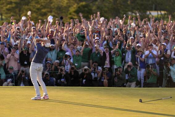The crowd cheers as Rory McIlroy, of Northern Ireland, celebrates winning the Masters golf tournament in Augusta, Georgia, April 13, 2025. (AP Photo/Ashley Landis)