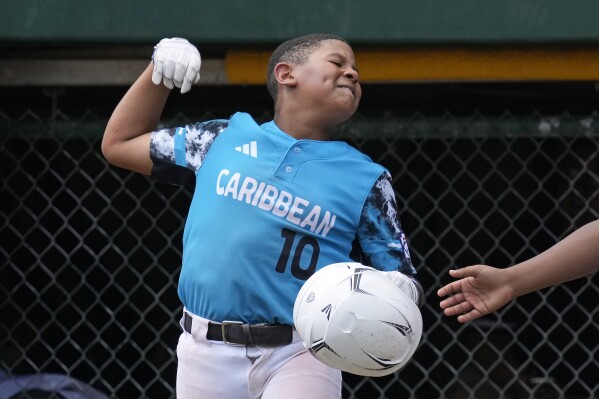 Curacao's Jay-Dlynn Wiel celebrates after scoring during the fourth inning of the International Championship baseball game against Taiwan at the Little League World Series tournament in South Williamsport, Pa., Saturday, Aug. 26, 2023. (AP Photo/Gene J. Puskar)