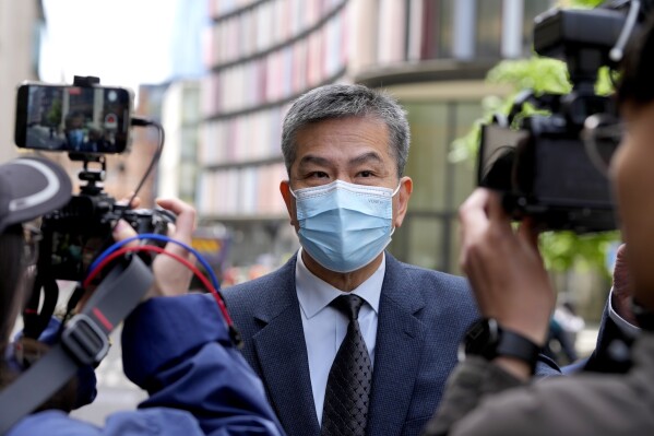 Chung Biu Yuen leaves The Old Bailey in London, Friday, May 24, 2024. Two men appeared in court Friday charged under the National Security Act with assisting the Hong Kong intelligence service and foreign interference. (AP Photo/Kirsty Wigglesworth)