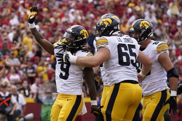 Iowa running back Jaziun Patterson (9) celebrates after scoring a touchdown during the first half of an NCAA college football game against Iowa State, Saturday, Sept. 9, 2023, in Ames, Iowa. (AP Photo/Charlie Neibergall)