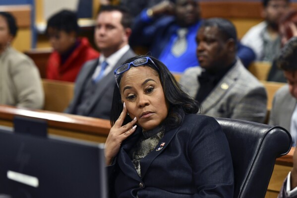 FILE - Fulton County District Attorney Fani Willis appears during a hearing regarding defendant Harrison Floyd, a leader in the organization Black Voices for Trump, as part of the Georgia election indictments, Nov. 21, 2023, in Atlanta. Accusations that Fulton County District Attorney Fani Willis had an inappropriate relationship with a special prosecutor she hired to seek convictions of Donald Trump and others for interfering in Georgia's 2020 election have led to renewed calls to remove Willis from the case. (Dennis Byron/Hip Hop Enquirer via AP)