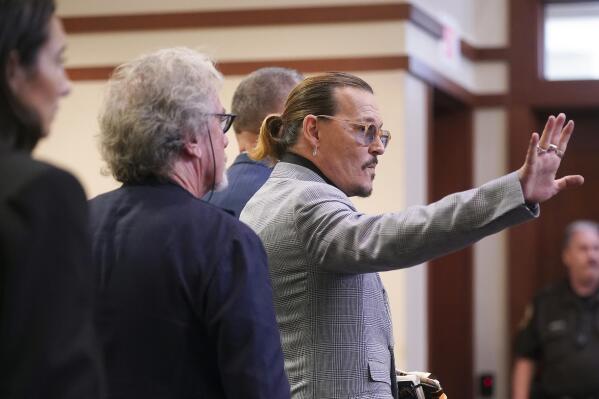 Actor Johnny Depp waves as he leaves the courtroom at the Fairfax County Circuit Courthouse in Fairfax, Va., Thursday, May 19, 2022. Actor Johnny Depp sued his ex-wife Amber Heard for libel in Fairfax County Circuit Court after she wrote an op-ed piece in The Washington Post in 2018 referring to herself as a "public figure representing domestic abuse." (Shawn Thew/Pool Photo via AP)
