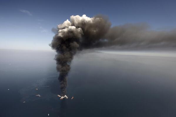 FILE - A large plume of smoke rises from fires on BP's Deepwater Horizon offshore oil rig in the Gulf of Mexico, more than 50 miles southeast of Venice on Louisiana's tip on April 2010. A new National Academy of Science study says that 13 years after a massive BP oil spill fouled the Gulf of Mexico, regulators and industry have reduced some risks in deep water exploration in the gulf but some troublesome safety issues persist. (AP Photo/Gerald Herbert, File)