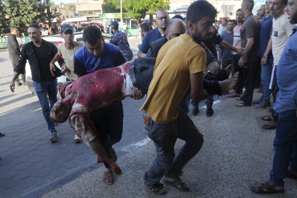 A Palestinian wounded in an Israeli bombardment is brought to a hospital in Deir el-Balah, Gaza Strip, Wednesday, Oct. 18, 2023. (AP Photo/Adel Hana)