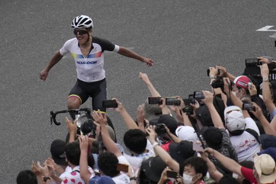 Richard Carapaz of Ecuador reacts after winning the men's cycling road race at the 2020 Summer Olympics, Saturday, July 24, 2021, in Oyama, Japan. (AP Photo/Christophe Ena)