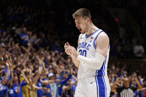 Duke's Kyle Filipowski (30) reacts after hitting a three-point shot during the first half of an NCAA college basketball game against Virginia in Durham, N.C., Saturday, March 2, 2024. (AP Photo/Ben McKeown)